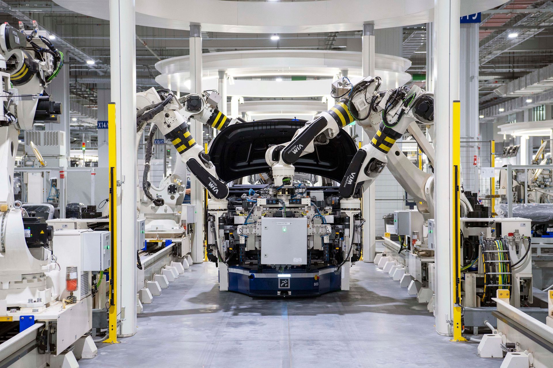 Schone fabriekshal met robotarmen en een geautomatiseerde assemblagelijn